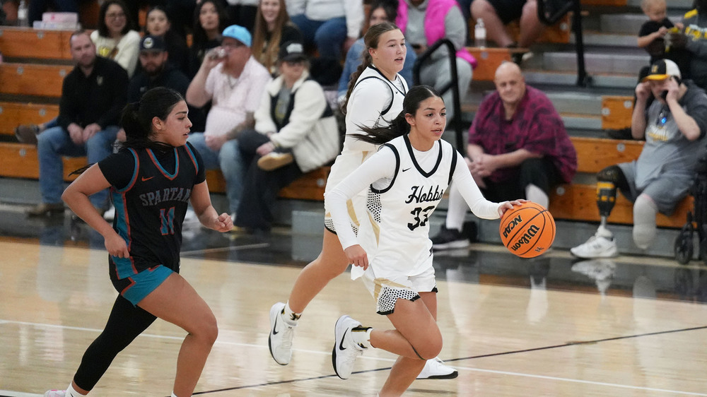three girl basketball players driving up court