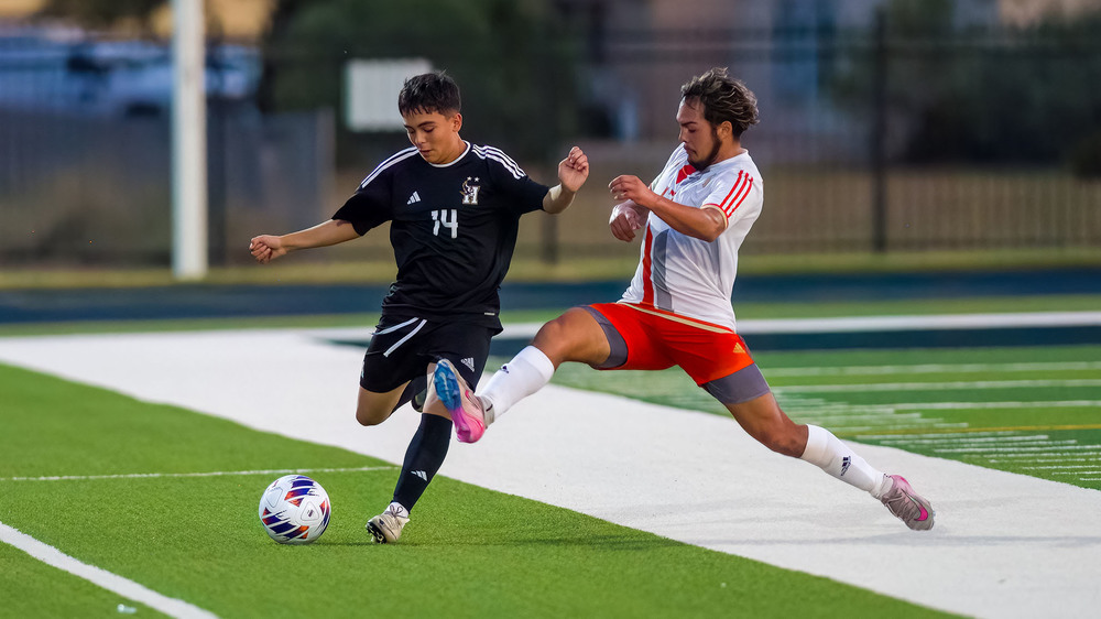 two players going for soccer ball