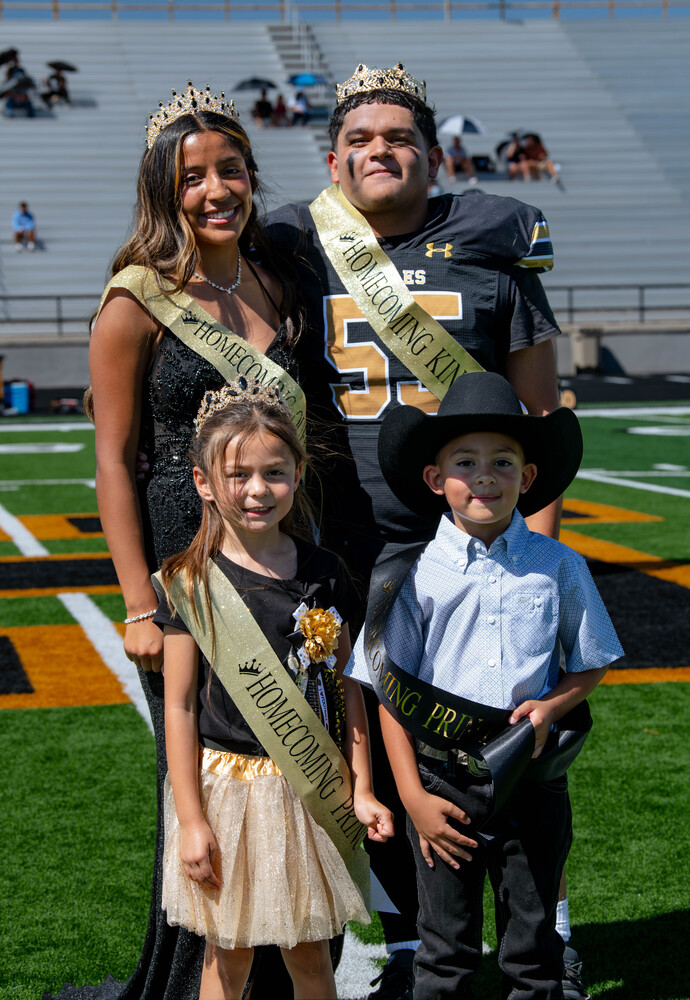 Homecoming King & Queen posing for a photo with the Princess & Prince
