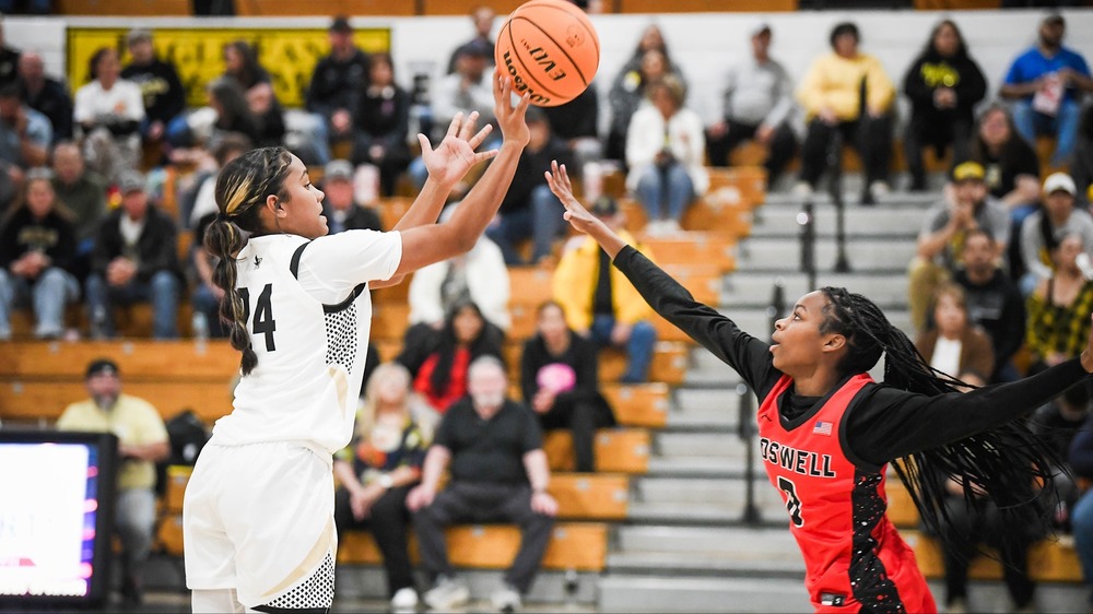 player going for trey shot with defender