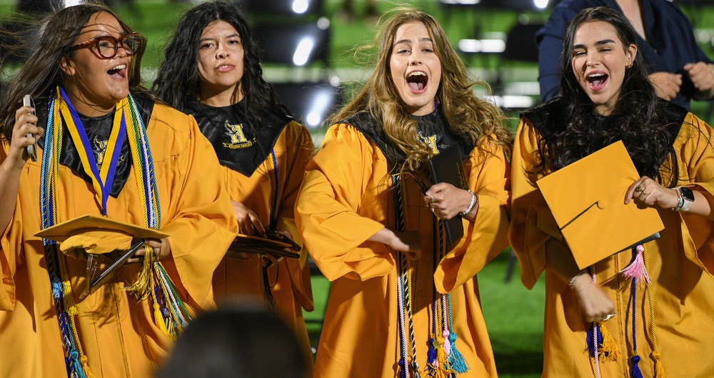 4 graduates being happy