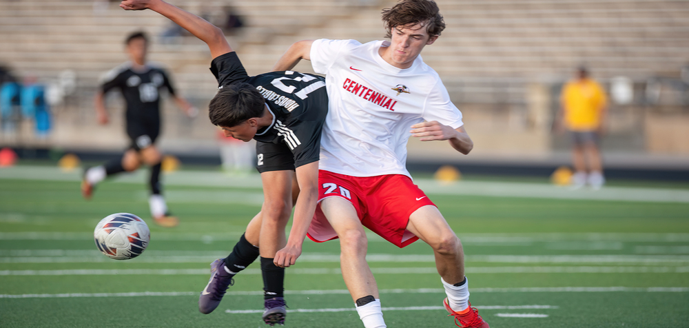 two soccer players competing