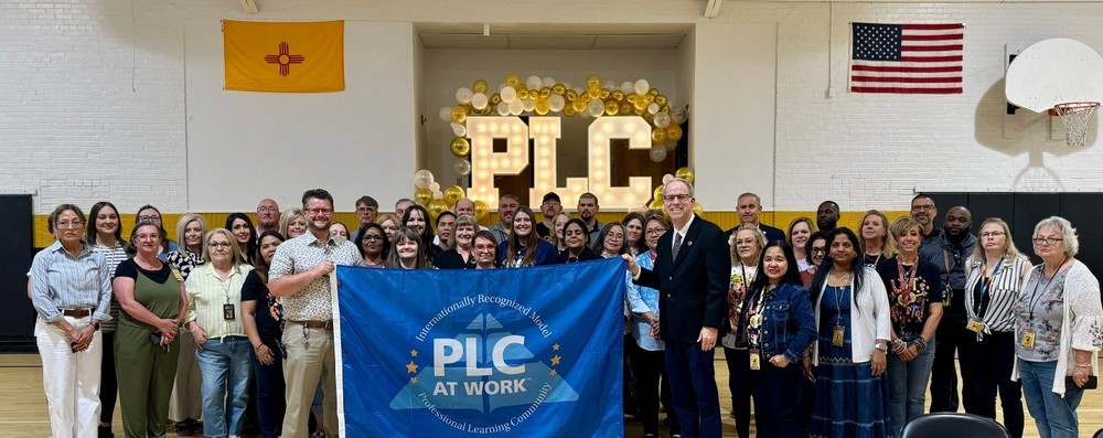 group photo with PLC banner