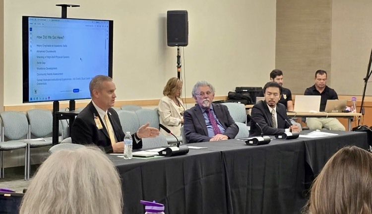 man presenting to committee