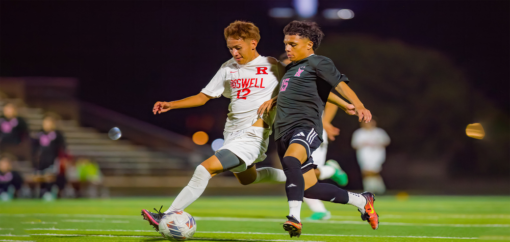 two soccer players competing