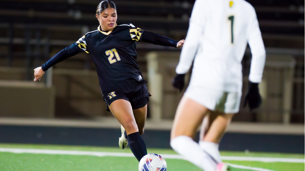 girl kicking soccer ball