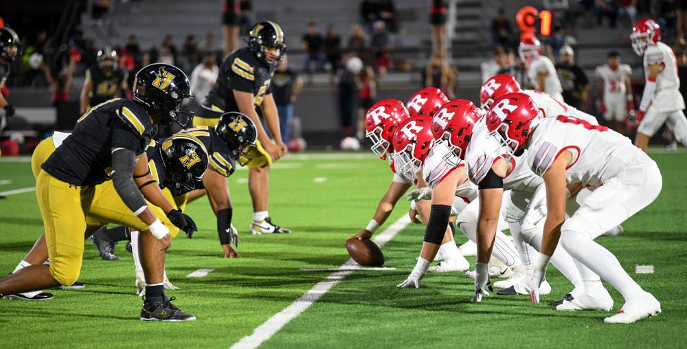 two football teams at line of scrimmage