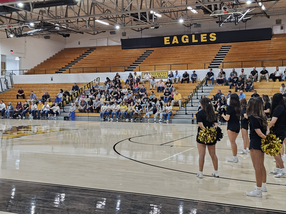 Hobbs High School Welcome Back Staff Members Assembly at Tasker Arena sitting on the bleachers with HHS cheerleaders, Band Drumline, and STUCO students. 