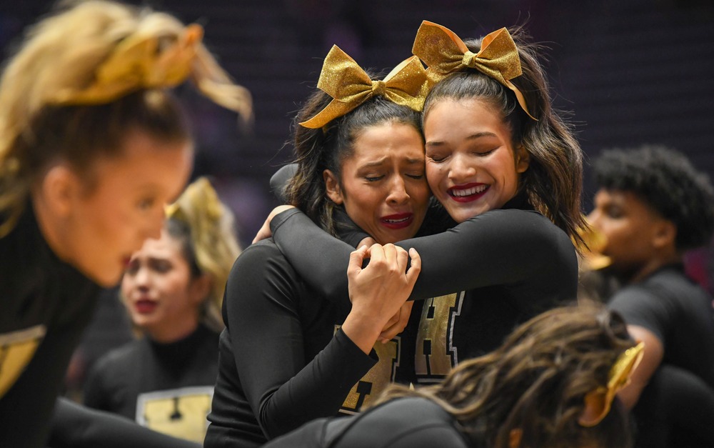 two cheerleaders hugging