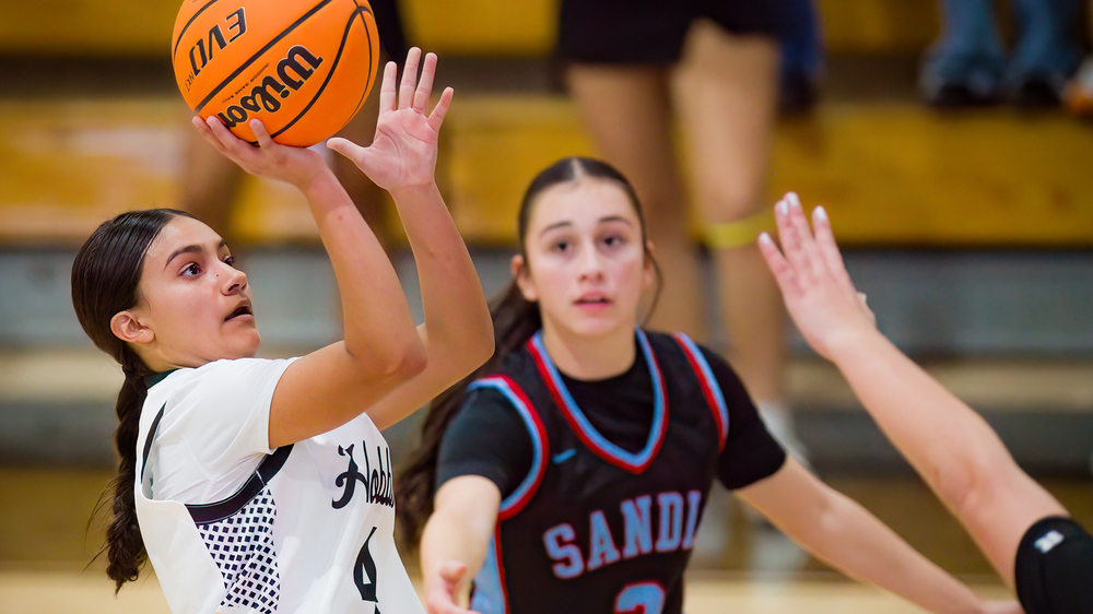 girl basketball player making shot