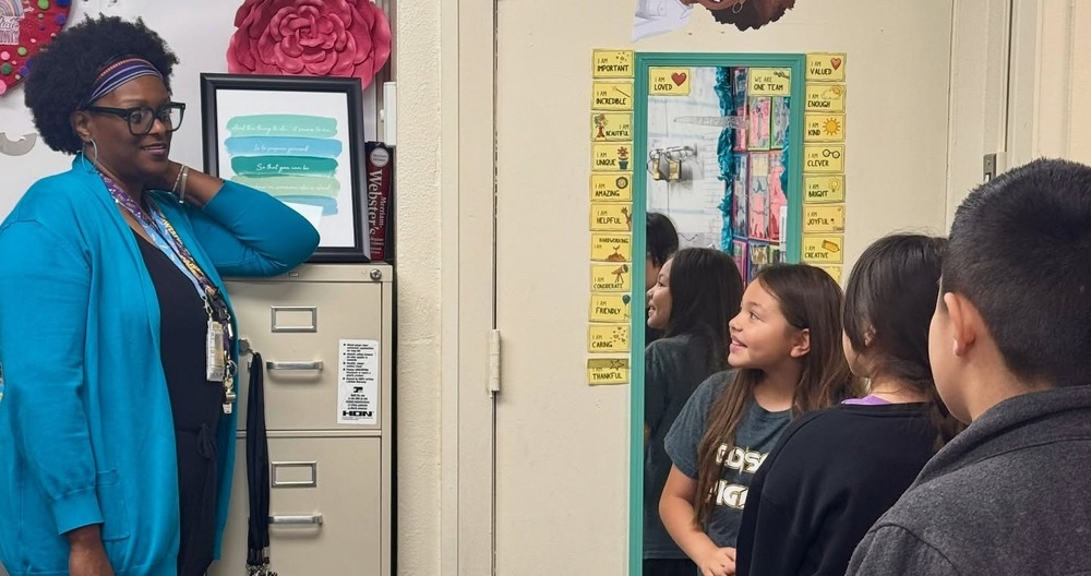 teacher looking at student looking in morror