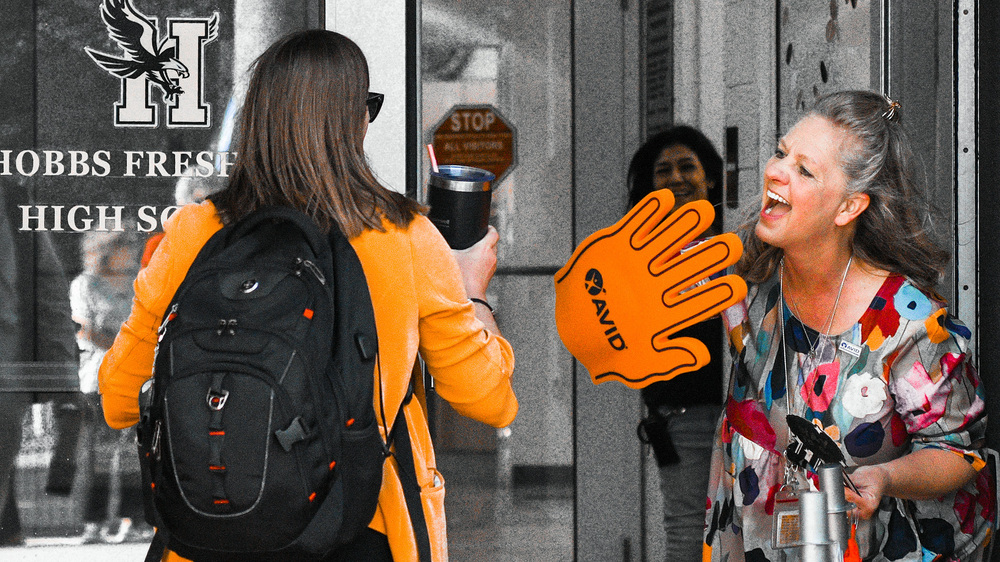 lady giving student a high five with a foam hand