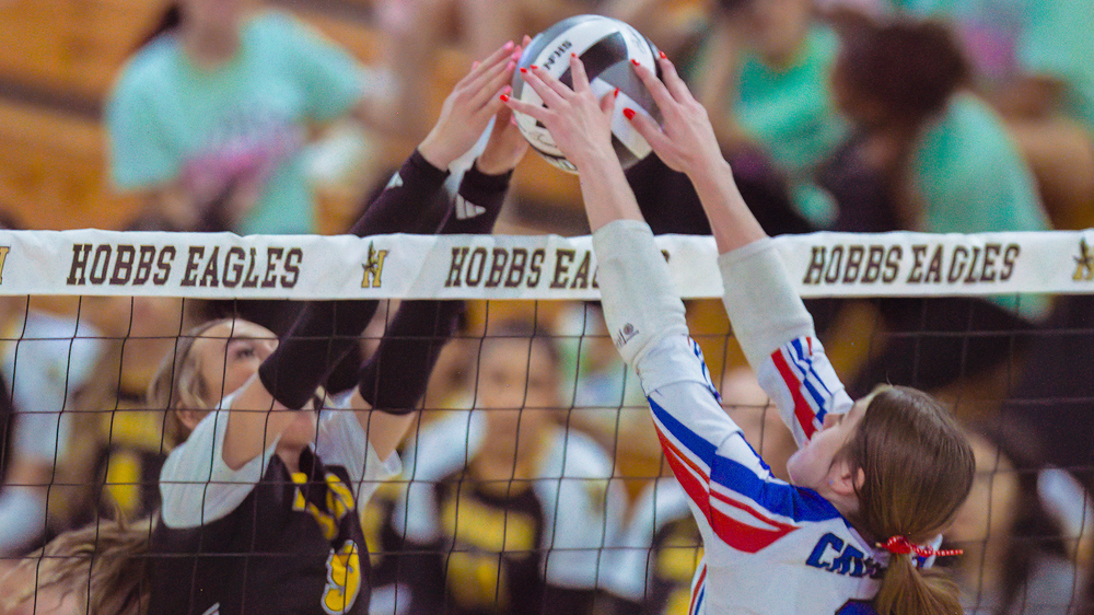 two volleyball players at net