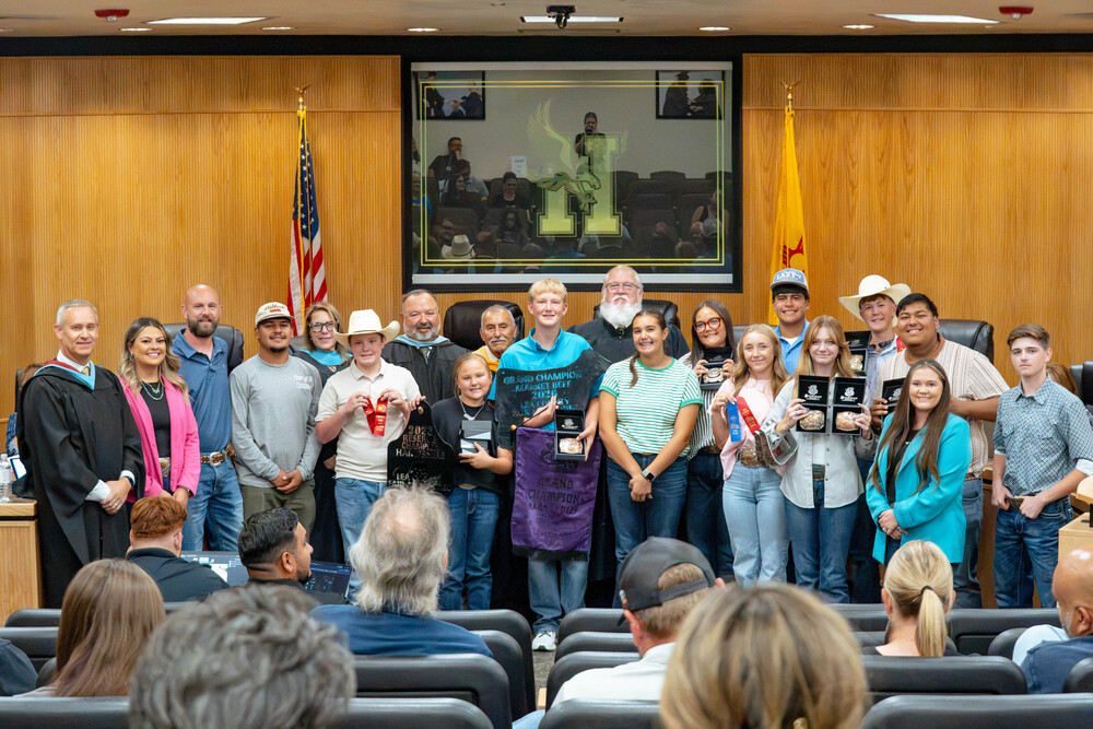 FFA students, smile alongside members of HMS School Board while showing off their winnings from the Lea County Fair and Rodeo