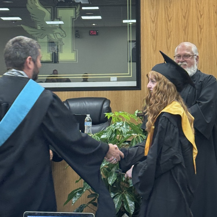 man shaking hand of student
