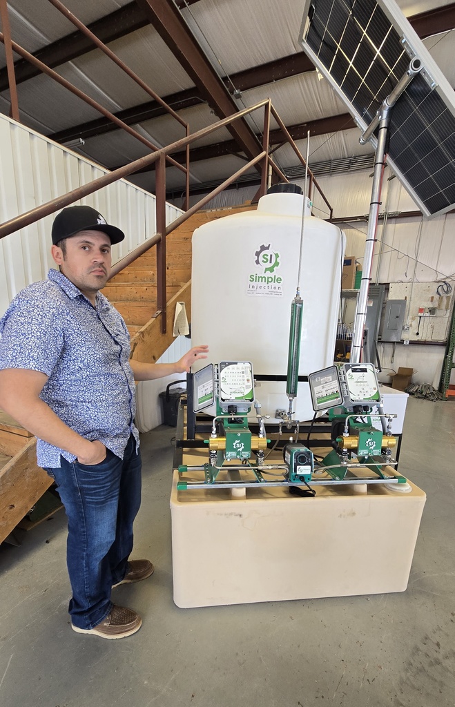 man standing next to a pump injector 
