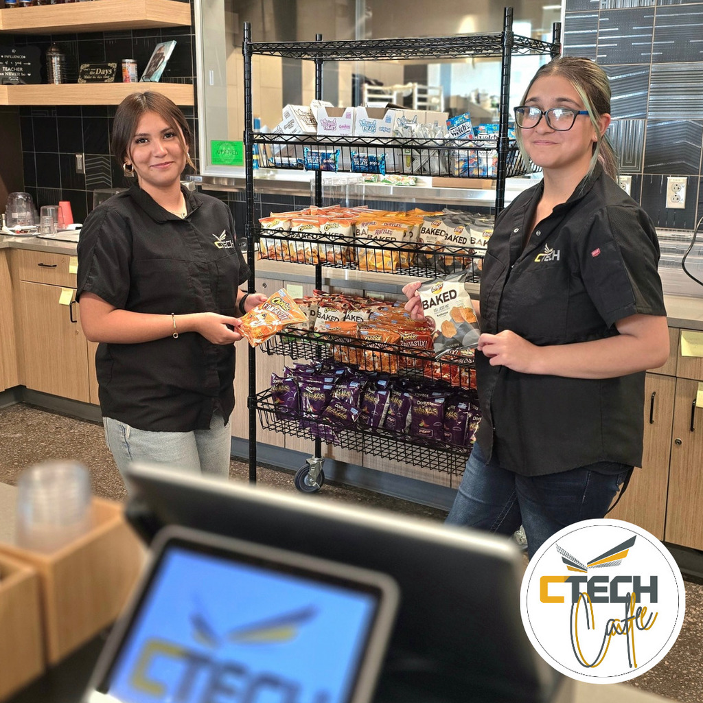 two girls standing holding chips in the cafe