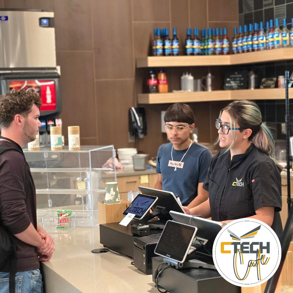 A boy ordering at the Cafe with boy and girl employees
