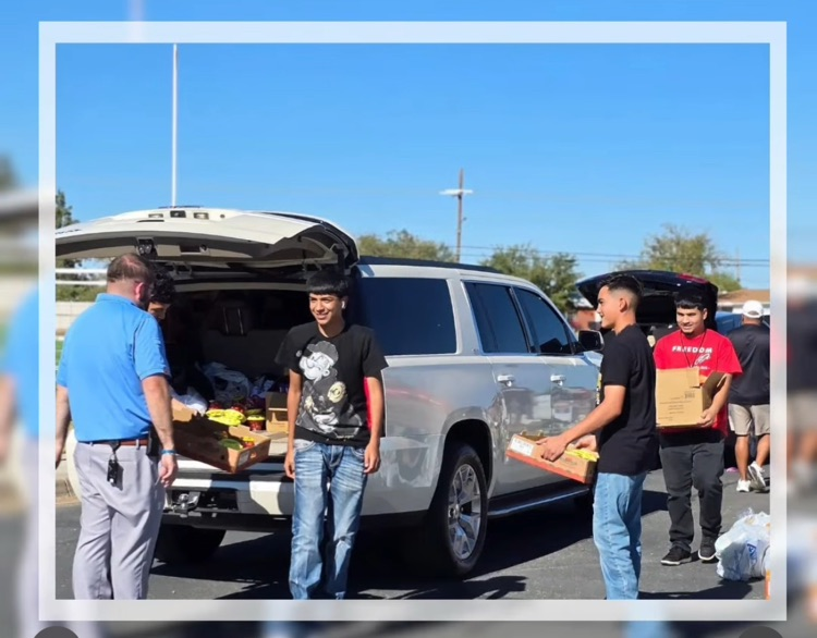 students loading car with boxes 