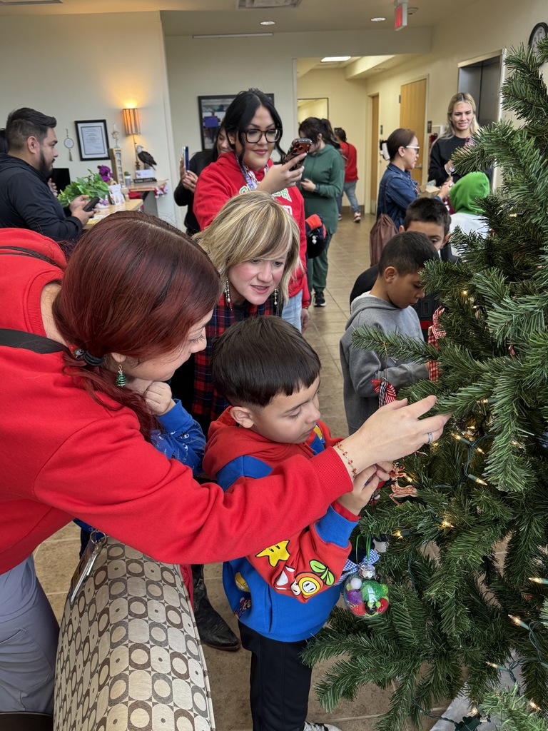 adukts and kid hanging ornaments
