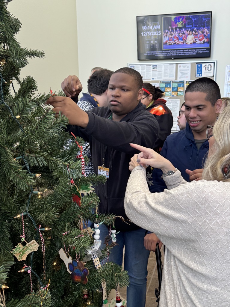 student hanging ornament