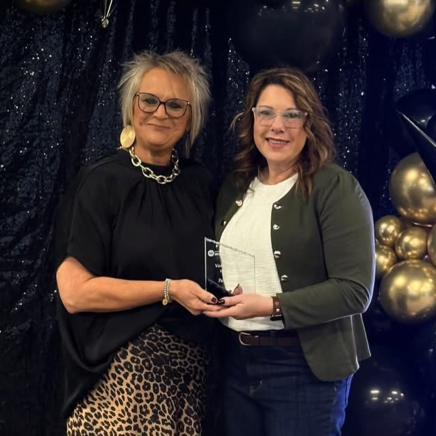 two ladies with award