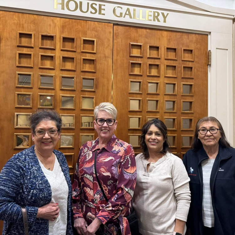 four ladies at a door