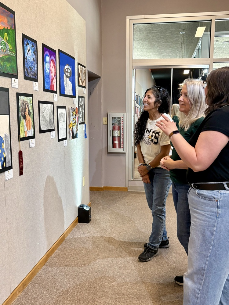 adults looking at art