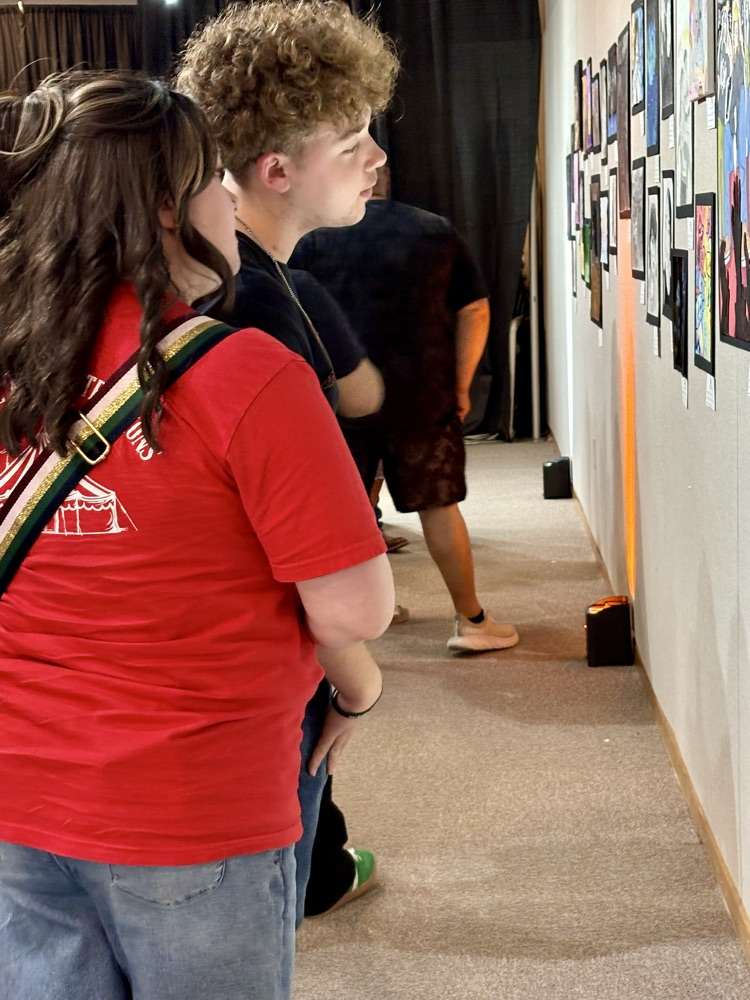 two people looking at painting 