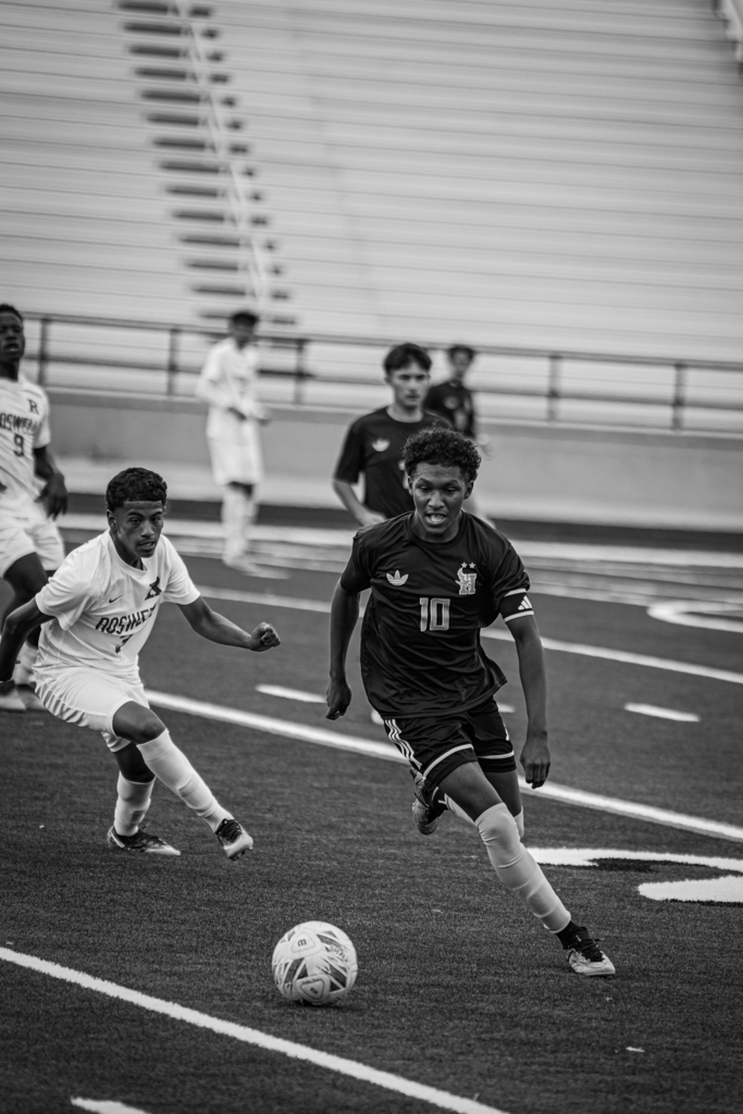 Hobbs Eagle Soccer player drives the ball in their match against Roswell