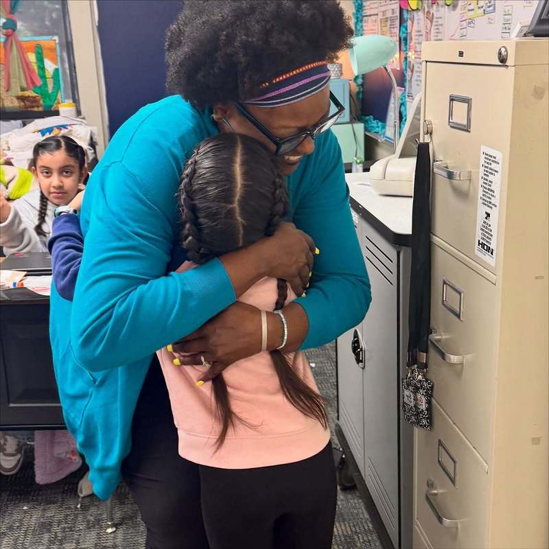 teacher hugging student