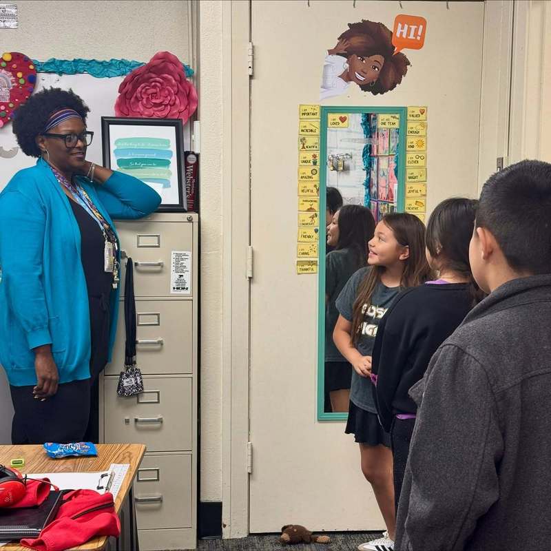 teacher speaking with students