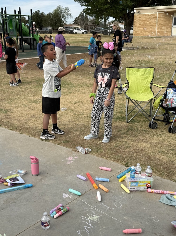 boy blowing bubbles at a girl