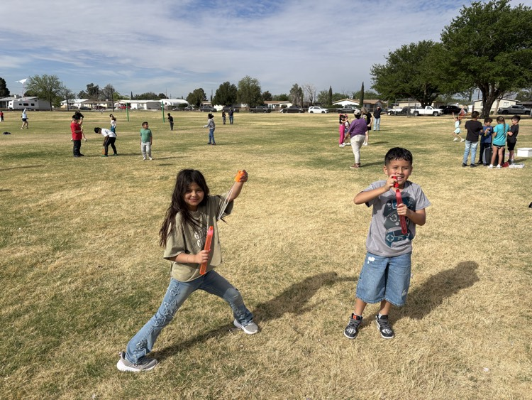 two kids blowing bubbles