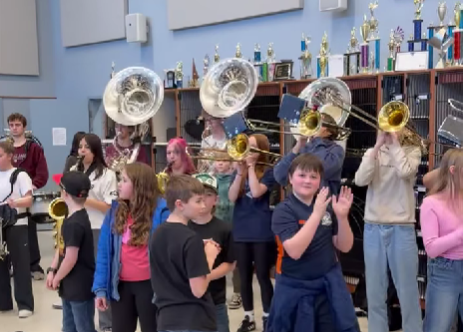 HHS Marching Band students dance and play for 5th Grade Band students in 2026.