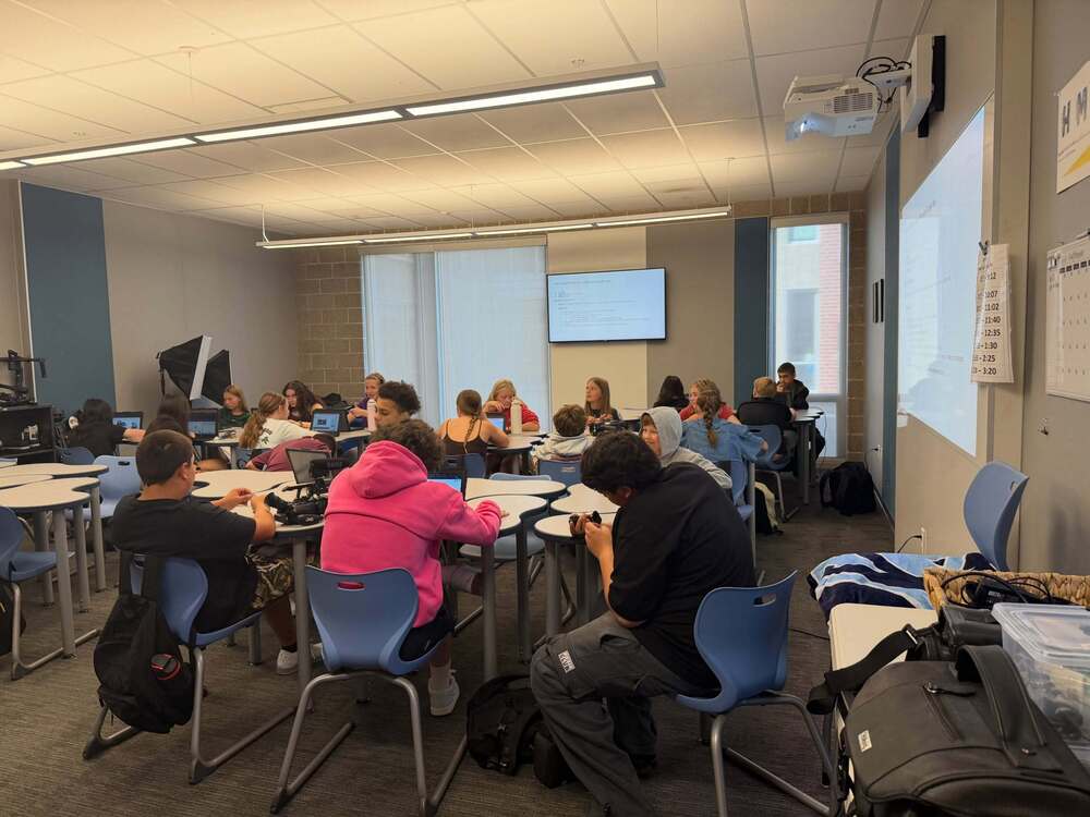 Middle school students sitting at desks in a classroom setting