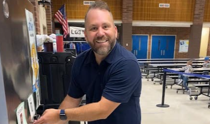 HHES Assistant Principal Olson serves student milk from new dispenser.