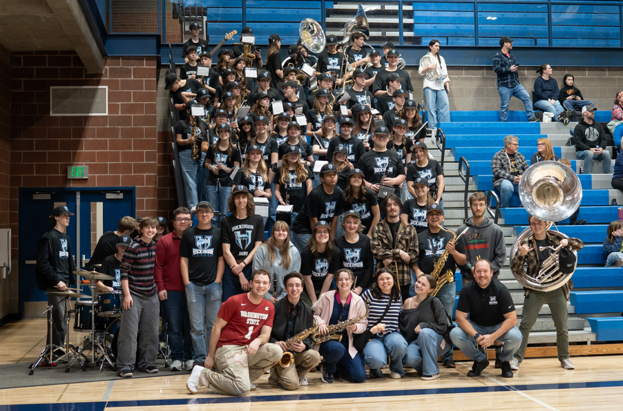HHS Band students stand together during the 2025 HHS Band Alumni Night.