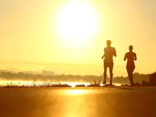 Image of two athletes running in the sun