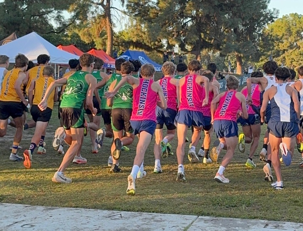 HHS Boys XC runners set off at the beginning of a 2025 race.