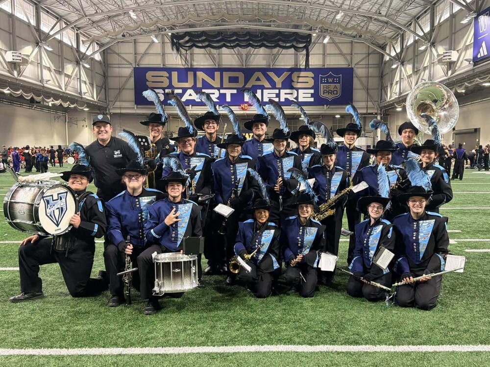 Members of the HHS Marching Band pose on Husky Field at the University of Washington. 