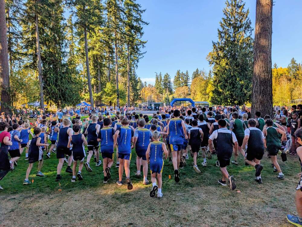 Group of cross county runners outdoors with trees
