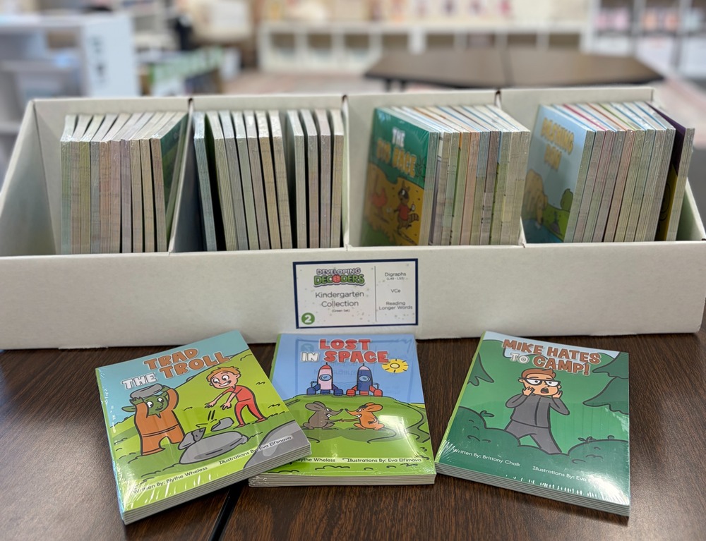 Decoding books on a desk in a welcoming classroom.