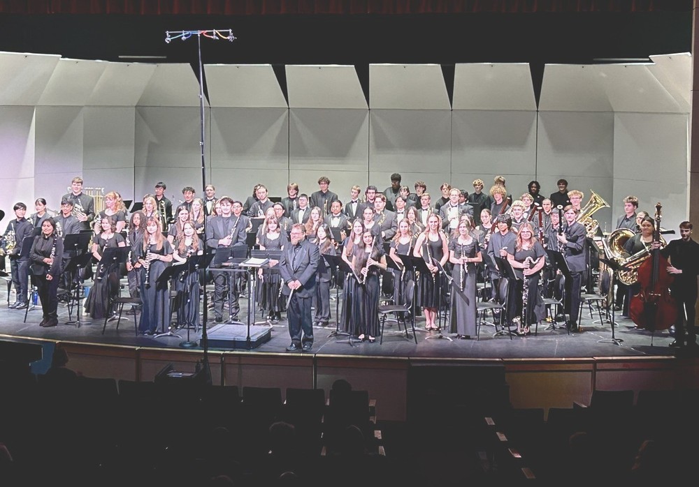 Group photo of band performing on stage