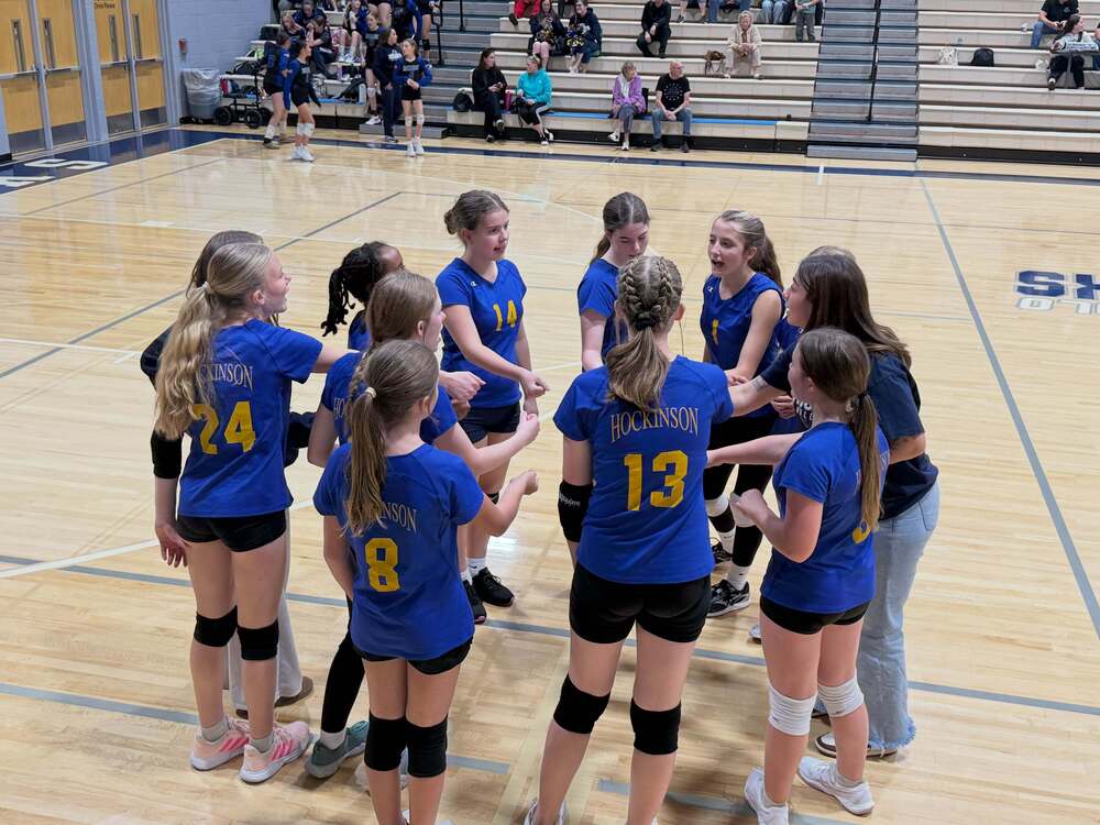 Photo of HMS Volleyball team in huddle