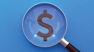 magnifying glass over dollar sign