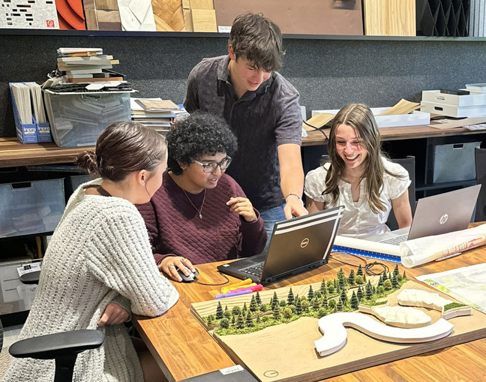 Picture of Karina Onofrey and students collaborating at model
