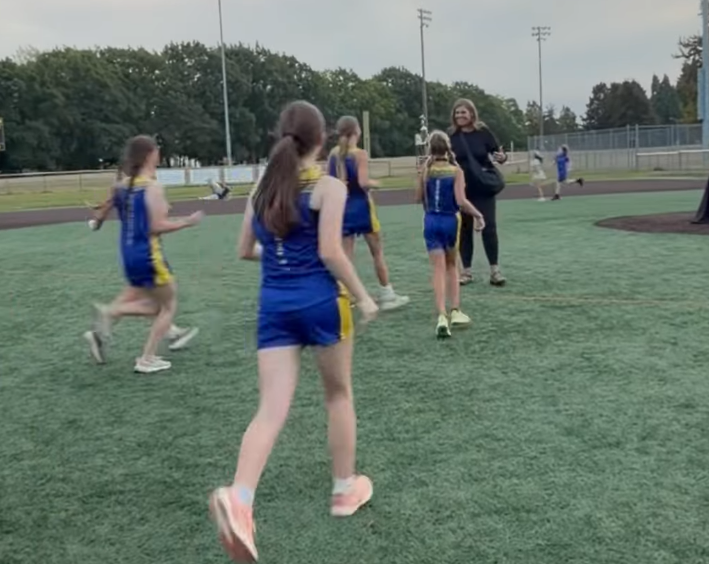 Members of the HMS Girls XC Team accept their Run-a-Ree Trophy