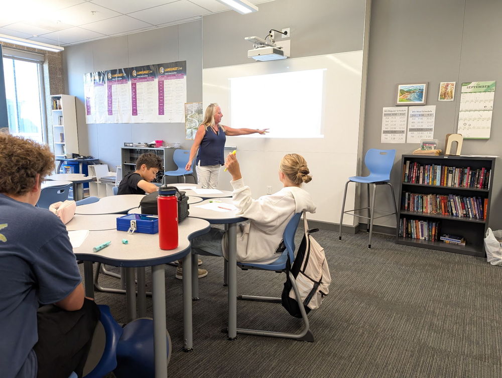 8th grade ELA Teacher Christine Parker pauses instruction after every passage of a common text to ask questions to assess how well students are comprehending what they read.