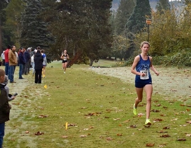 A photo of Graysen Aldridge running at the 2025 District XC Meet